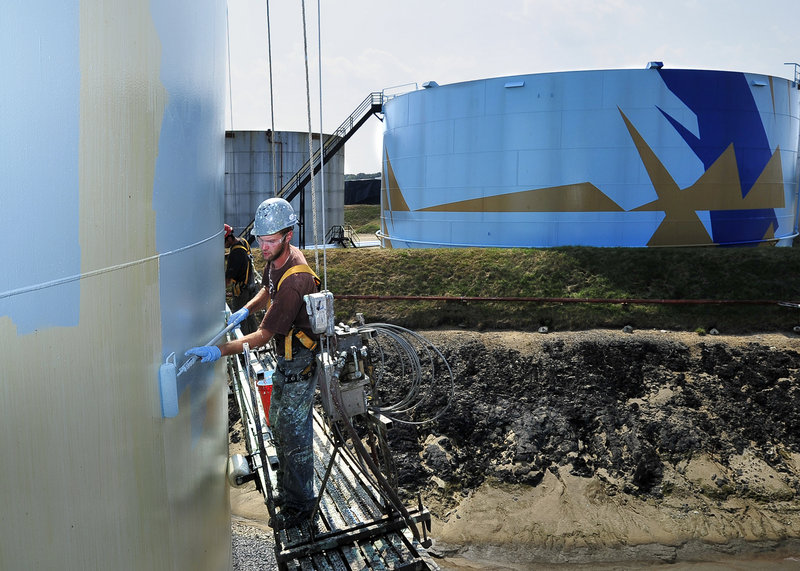 WORKERS APPLIED THE base coat of paint to the third tank in the Art All Around project Wednesday at the Sprague Energy tank farm in South Portland. It will take about a month to complete the tank, which will be clearly visible from the Veterans Memorial Bridge. Sponsored by the Portland-based Maine Center for Creativity, the project will be the largest public art painting in the world after the fourth tank is completed. In all, the project will involve painting eight complete tanks and eight tank tops. On Wednesday, Jean Maginnis, executive director of the Maine Center for Creativity, announced that the organization had received an anonymous $100,000 challenge grant. The center has until Sept. 30 to match the grant. If the challenge is met, the center will have raised $855,000 toward its goal of $1.4 million.