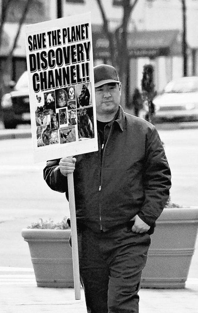 In this photo from Feb. 14, 2008, James J. Lee holds a protest sign in front of the headquarters of the Discovery Channel networks in Silver Spring, Md.