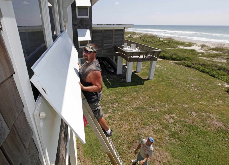 Scott Reese packs up his surfboards in Atlantic Beach, N.C., today as he prepares to evacuate.