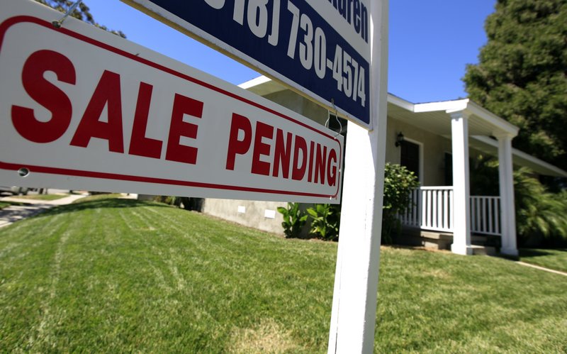Sales of new and previously owned homes fell to a record low in July, despite the falling mortgage rates.