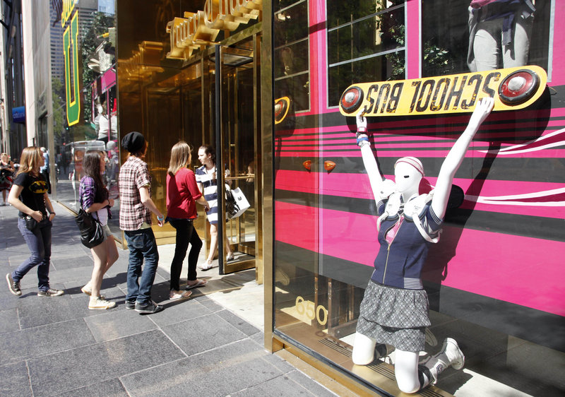 Teenagers enter a Juicy Couture store in New York City. Retailers report gains for August, helped by students’ shopping.