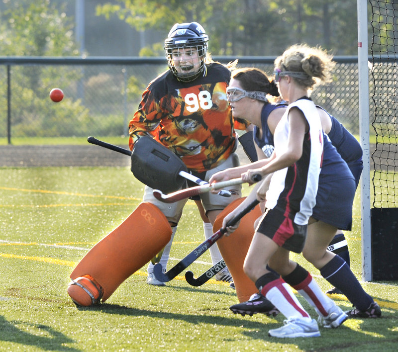 Portland goalie Kathleen Dalbec, who had 14 saves Thursday in the field hockey opener against Scarborough, deflects the ball away during a Red Storm surge. Scarborough opened its defense of the Class A state championship with a 5-1 victory.
