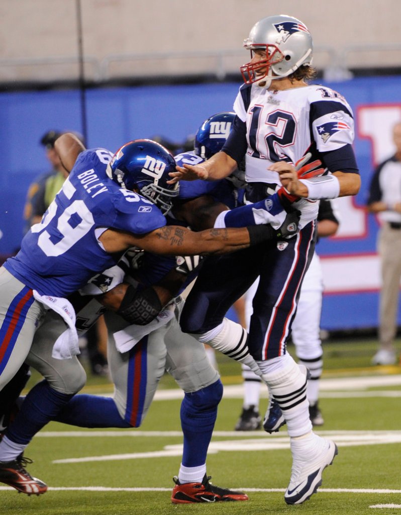 Tom Brady, who hit 4 of 8 passes for 51 yards for the New England Patriots, gets the ball off against a hard rush during the first quarter of a 20-17 loss to the New York Giants.