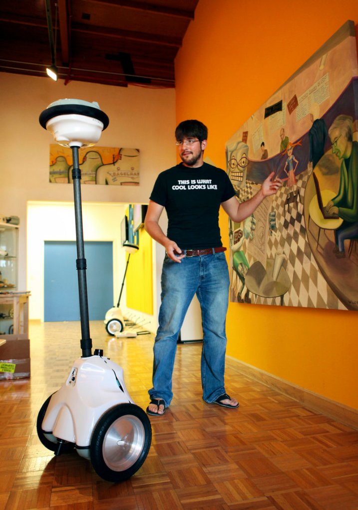 Robert Martinez, a mechanical engineer, demonstrates a QB robot at Anybots’ offices in Mountain View, Calif.