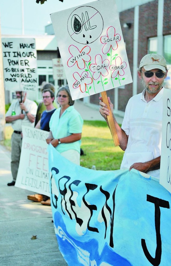 Dan Rynberg of Yarmouth protests Senate inaction on climate change Wednesday outside the Muskie Federal Building in Augusta.