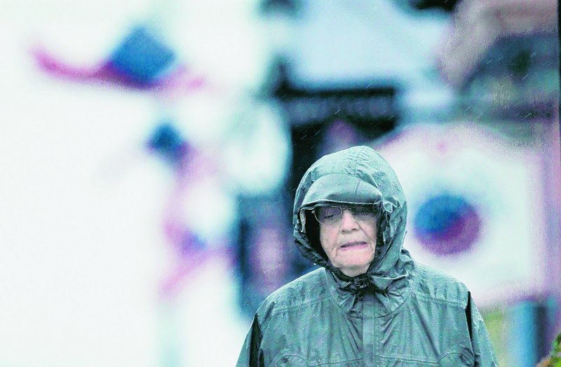 Cathy Black of Dayton, N.J., walks in the rain on the final day of her two-week stay in Lubec as Tropical Storm Earl blows through on Saturday.