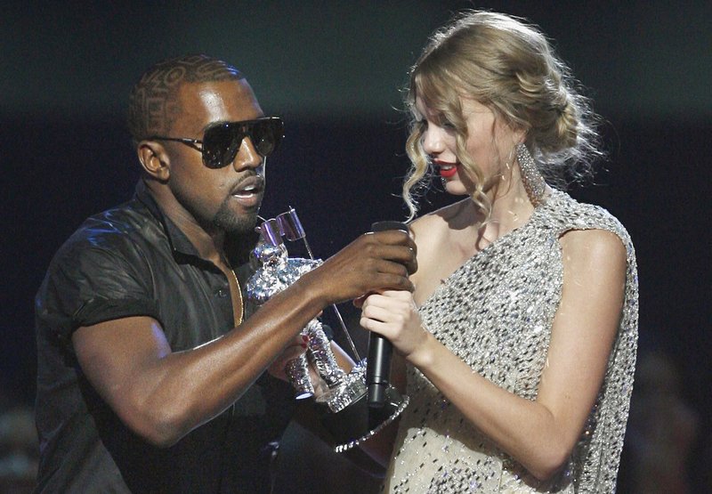 Kanye West takes the microphone from Taylor Swift as she accepts the “Best Female Video” award during the 2009 MTV Video Music Awards. West tweeted Saturday that he was wrong and his career had suffered.