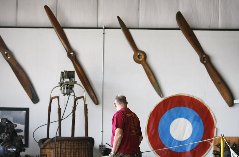 Glenn Snow of Marshfield, Mass., walks by a display of antique propellers while visiting the Vintage Motorcycle Meet and Antique Aeroplane Show at the Owls Head Transportation Museum in Owls Head on Saturday. Snow, who was on his way to Seboeis for the weekend, says the transportation museum is a "regular stop" for him while in Maine.