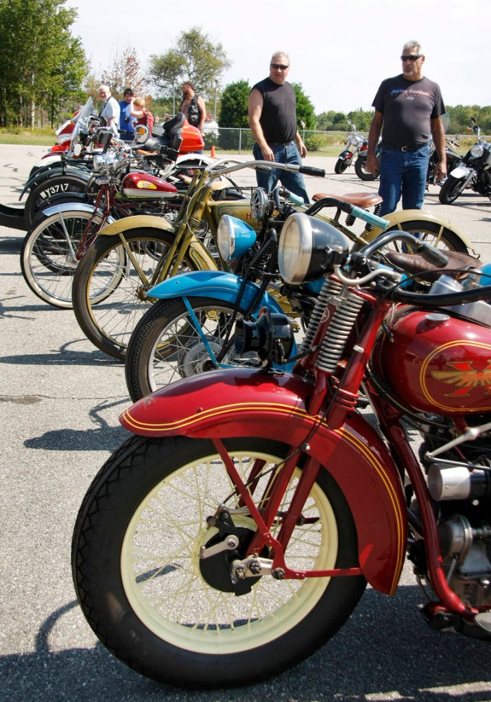 Visitors check out vintage motorcycles displayed at the Owls Head show Saturday.