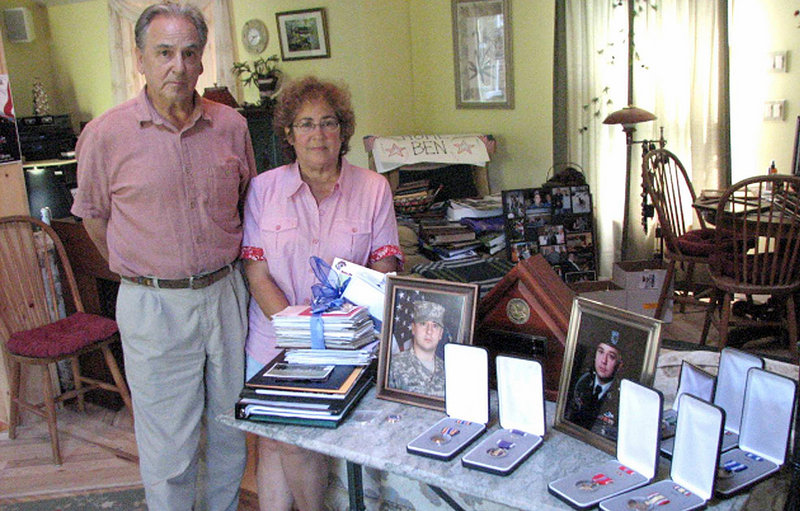 Bill and Beverly Osborn of Queensbury, N.Y., display photos, medals, letters and other mementos of their son, Army Spc. Benjamin Osborn, 27, who was killed in a Taliban ambush in Afghanistan in June. The Osborns said members of their son’s unit told them he had to wait to return fire until he was ordered to do so. He got off 10 rounds before he was killed, they said.