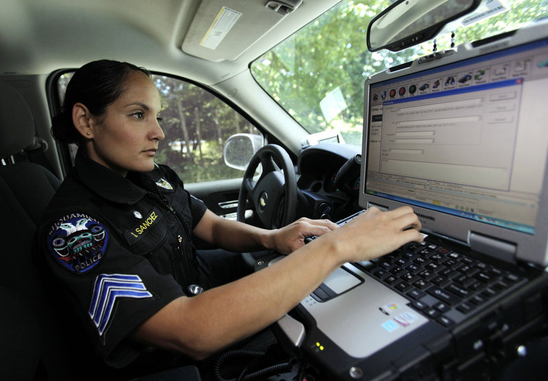 Sgt. Swift Sanchez of the Suquamish Tribal Police logs a call on a computer while on patrol on the Suquamish Reservation in Washington state. Tribal officials and legal experts say the system used to mete out justice on reservations creates confusion that can lead to delays and overturned convictions.