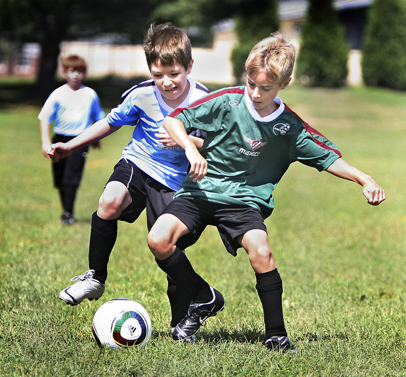 U10 players Gavin Chambers, left, and Max Brown of Portland fight for the ball on Monday during opening day of the Portland Area Youth Soccer Association’s U8 and U10 recreational divisions.
