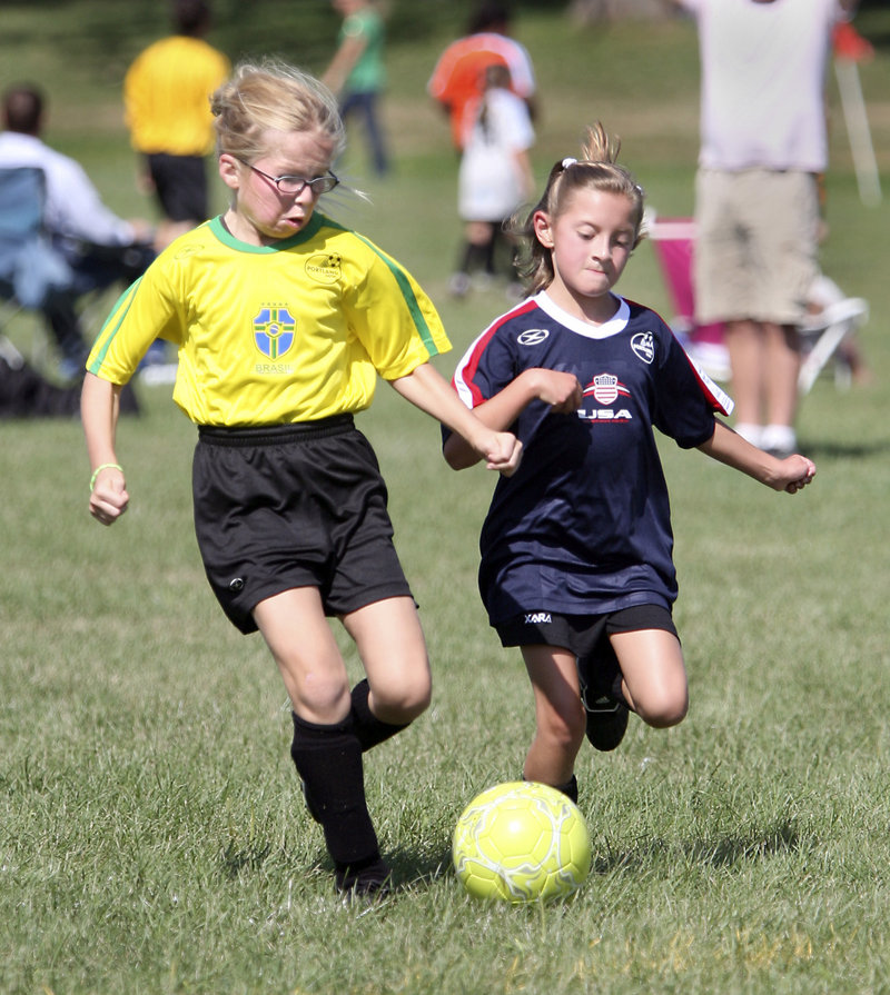 Mary Jerome of Brazil, left, tries to get a step on Hannah Collum of USA during their U10 girls match. U10s play 6 vs. 6 with goalkeepers.