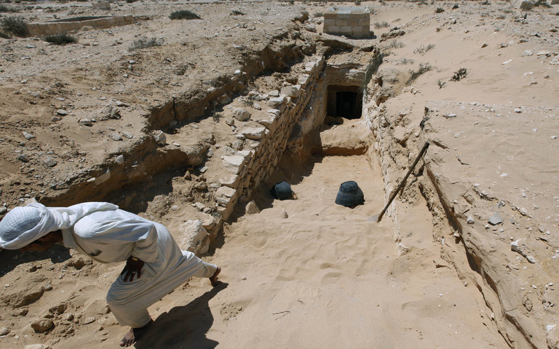 An Egyptian laborer works at the entrance of a tomb under restoration at the ancient city of Leukaspis, a well known Greco-Roman port overlooking the Mediterranean Sea at the costal resort of Marina, Egypt on Sunday. Ancient tombs were discovered by road engineers in 1986.