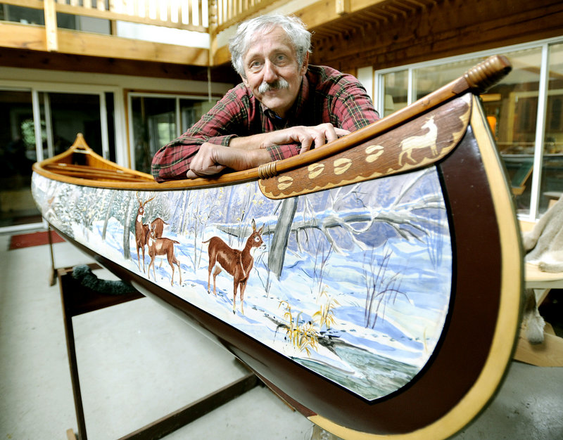 Jerry Stelmok, the owner of Island Falls Canoe in Atkinson, leans on a Millennium Sojourner he painted by hand. When Old Town Canoe and Kayak closed its plant in Old Town a year ago and moved to a smaller facility, it selected Stelmok’s company to produce its wooden canoes because of his attention to detail.