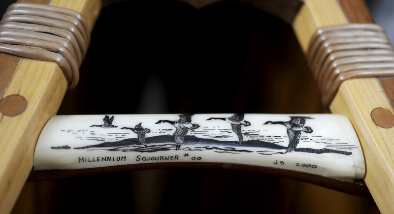 A piece of moose antler with geese carvings by Jerry Stelmok serves as a handle on his limited edition Millennium Sojourner wooden canoe.