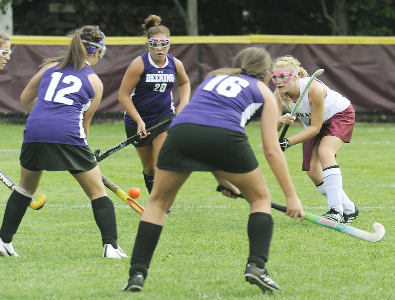 Kelsey Pequinot of Gorham, right, fires a shot through the Deering defense that included Jesse Cinque, 12, and Harmony Therrien, 16, during Gorham’s 3-0 victory in an SMAA field hockey game Wednesday at Gorham.