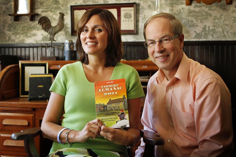 Farmers’ Almanac managing editor Sandi Duncan, left, and editor Peter Geiger pose in Lewiston last month with a copy of the 2011 edition. The publication, which uses a “secret formula” to predict the weather, remains popular with readers.