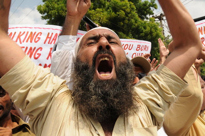 A protester shouts slogans during a rally Thursday in Multan, Pakistan, in reaction to a Florida pastor’s plan to burn copies of the Quran on the ninth anniversary of the Sept. 11 attacks. About 200 people marched in Multan and burned an American flag. President Obama and Defense Secretary Robert Gates asked the Rev. Terry Jones to call off the event, warning it could lead to violence against American forces in Iraq and Afghanistan. “(It) is completely contrary to our values as Americans,” Obama said.
