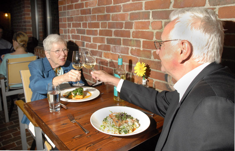 Pat Brown and Jim Morgan raise a toast as they’re about to dig into their meals at Havana South in Portland.