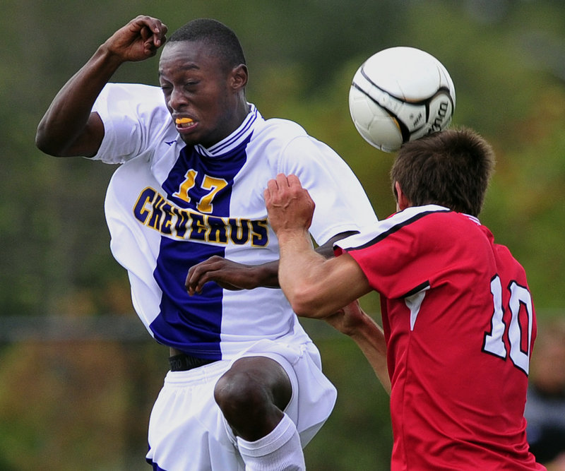 Andrew Guillemette of Sanford, right, heads the ball away from Raphael Tshamala of Cheverus in the first half of their schoolboy soccer game Thursday. Cheverus scored twice in the first half and once in the second to win, 3-0.