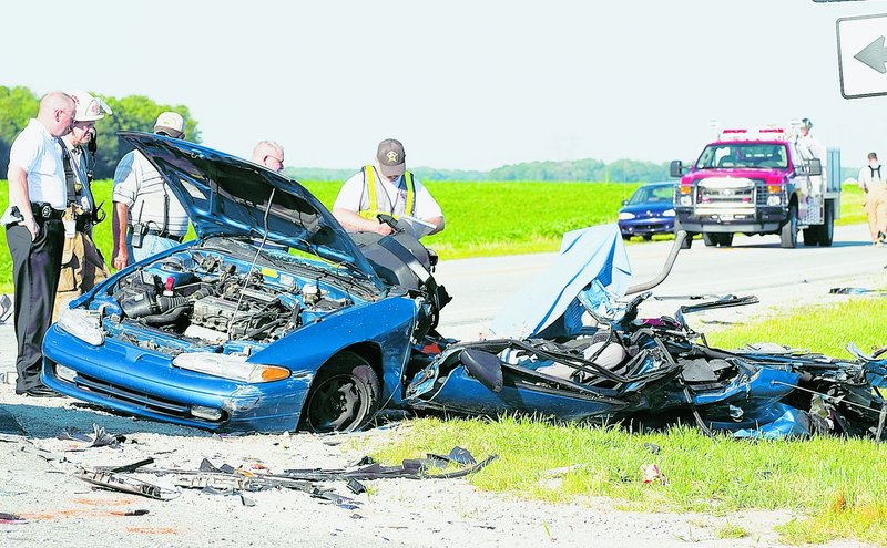 Indiana firefighters, sheriff’s deputies and deputy coroners examine the wreckage of a car involved in a fatal crash in 2008. Nationwide traffic deaths in 2009 fell to their lowest level since 1950.