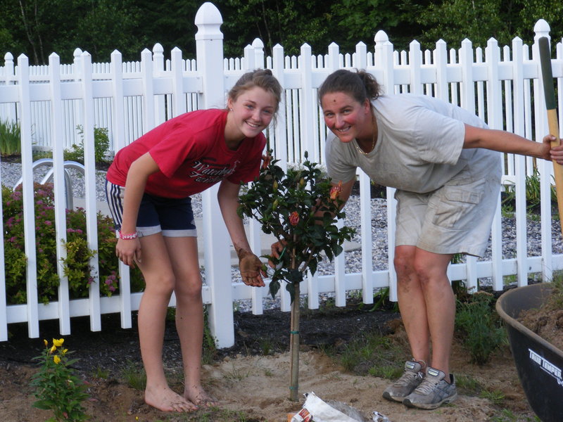 Laura Pate, right, is pictured with her niece Katlyn Barden gardening at Lisa Pate-Barden’s house in Dayton.