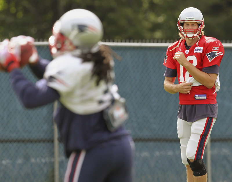 Tom Brady tosses a pass caught by running back Laurence Maroney during the Patriots’ practice Thursday. Brady was unhurt in a car accident earlier in the day.
