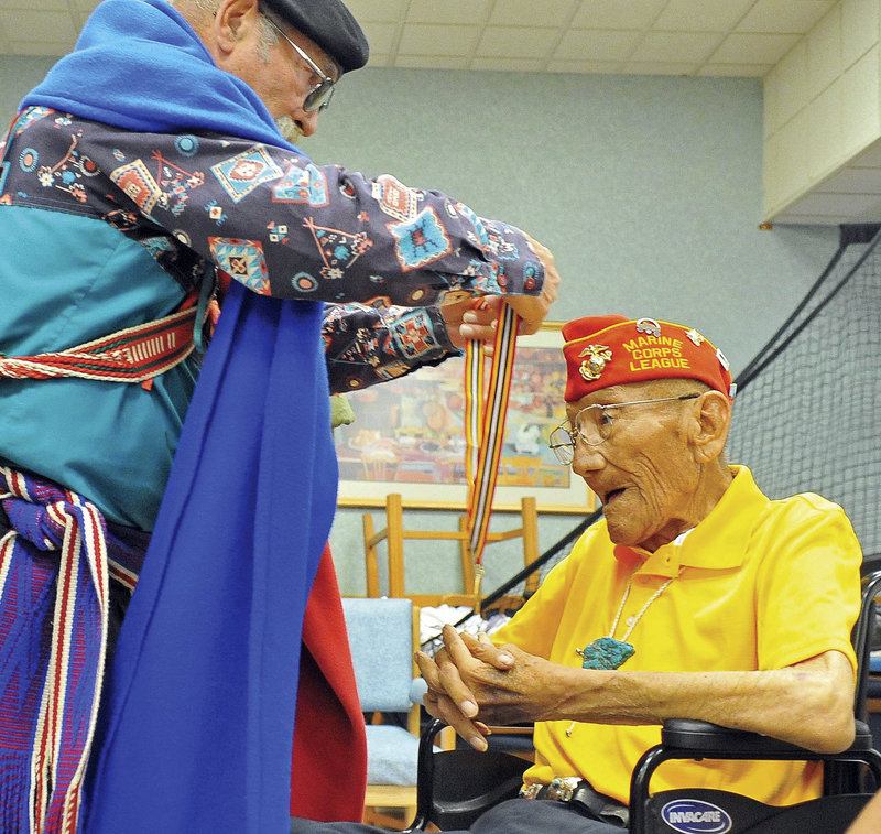 Larry Kimmel, with the Military Order of the Purple Heart, awards the Warriors Medal of Valor to Sgt. Allen D. June, one of the 29 original Navajo Code Talkers, at the Bob Stump VA Medical Center in Prescott, Ariz., on July 29.