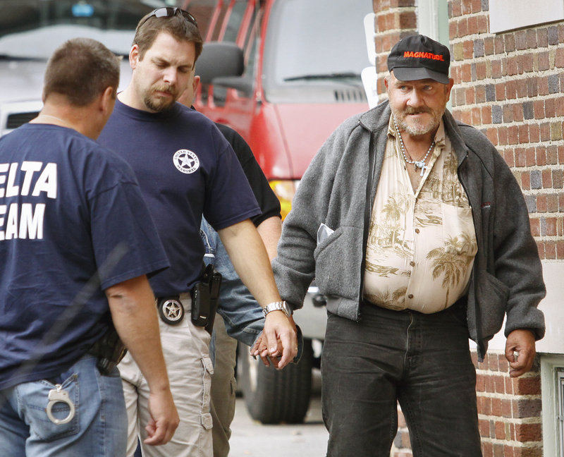 Philip Gurney, right, a 49-year-old transient, is taken into custody Friday in Portland by Mike Tenuta, sex offender investigations coordinator for the Portland Police Department, and Detective Andy Haggarty. A warrant had been issued for the convicted sex offender after police said he failed to register multiple times.