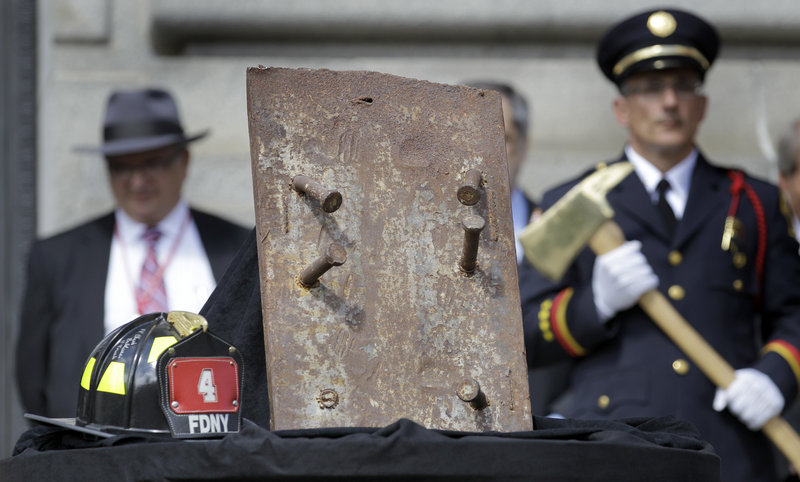A piece of steel from the World Trade Center, and a firefighter’s helmet signed by surviving members of New York City’s Station 4 are seen at Cleveland’s Patriot Day Ceremony on Friday. Cleveland this year focused attention on those who died in the attacks of Sept. 11, 2001.