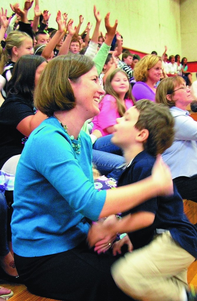 Shelly Moody, who teaches at Williams Elementary School in Oakland, holds onto her son, Jacob, 5, Friday morning as she is announced as the 2011 Maine Teacher of the Year. Last year’s winner was Kevin Grover of Falmouth.