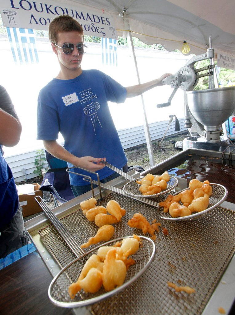 Jesse Kroger, 17, makes loukoumades, Greek honey puffs, at the festival in Lewiston on Saturday.