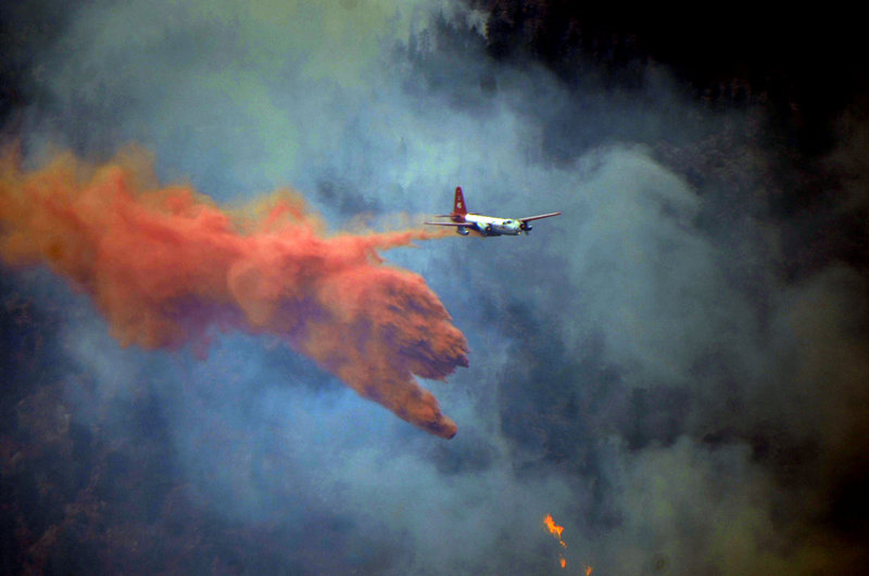 An aircraft drops fire retardant ahead of flames near Sunshine Canyon, in Boulder County, Colo., on Sept. 7.