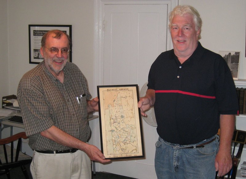 Stanley Howe, left, associate director of the Bethel Historical Society, and Joe Gaidis of Gaidis Antiques & Auctions hold a map of Oxford County created in 1835 by 12-year-old Bethel native Lydia Carter.