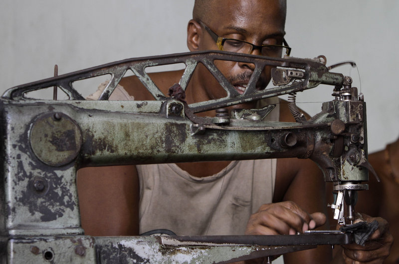 Manuel Cardenas repairs shoes in the state-run La Habanera workshop in Havana on Monday. Raul Castro’s government said Monday it will lay off 500,000 state employees by mid-2011 and increase private-sector opportunities – a significant change for the communist-run island.