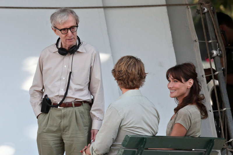 Carla Bruni-Sarkozy, the first lady of France, talks with director Woody Allen, left, and American actor Owen Wilson during the filming of “Midnight in Paris” on July 28 in Paris. Bruni-Sarkozy plays a museum tour guide in the movie.