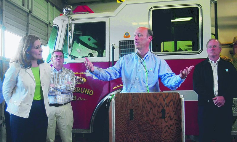 Chris Johns, right, president of Pacific Gas & Electric Co., addresses reporters’ questions in response to a gas pipeline explosion in San Bruno, Calif., on Monday. The utility said it has set aside up to $100 million to help residents recover.