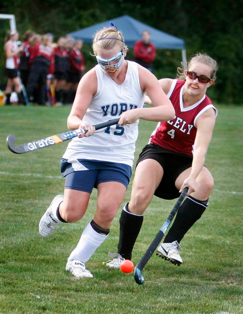 Emily Curato, right, of Greely knocks the ball away from Catie Keenan of York during their Western Maine Conference field hockey game Monday. York remained unbeaten with a 3-0 victory.