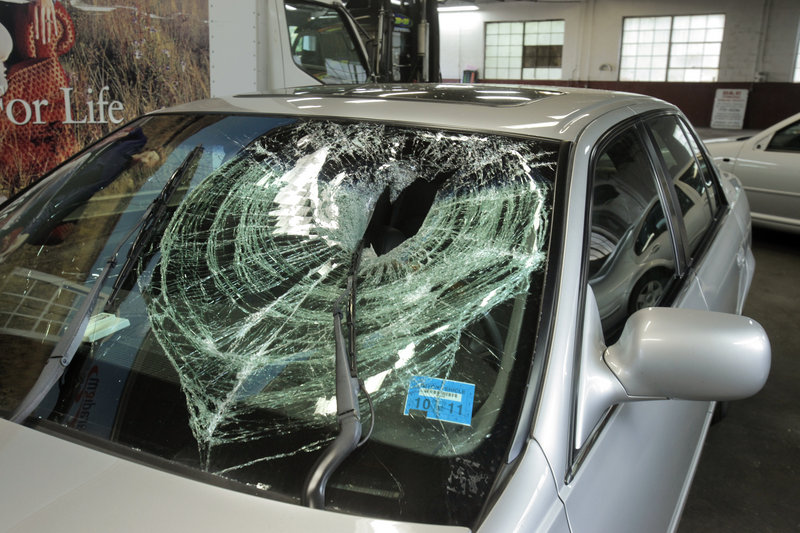 A football-sized rock dropped from the railroad bridge near St. John Street in Portland on Saturday hit the windshield of this 2002 Cadillac driven by Peter Brichetto.