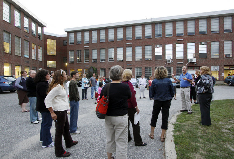 Tour participants listen to Scott Pakulski, an architectural designer with Harriman Associates, talk about the renovation plans for South Portland High School on Tuesday.