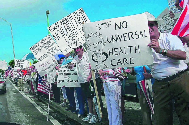 Protesters rally in Miami. The states and the administration disagree over whether people should be required to have health insurance, and whether states should pay additional Medicaid costs not covered by the federal government.