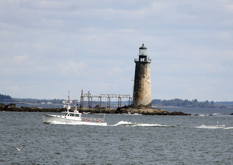 Ram Island Ledge Light is seen Tuesday from a tour boat in Casco Bay. Now that it is in private hands, it will be placed on the tax rolls. But it’s unclear whether it is in Cape Elizabeth, as the federal government thinks, or Portland, as locals believe.