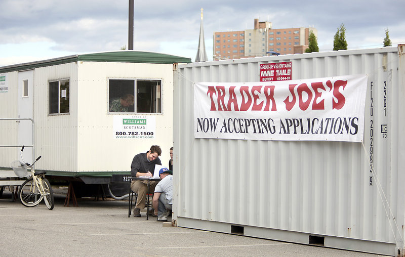 Ryan Hall of Portland fills out a job application Thursday outside the new Trader Joe's store on Marginal Way in Portland. The company hopes to open the store by the end of the year.