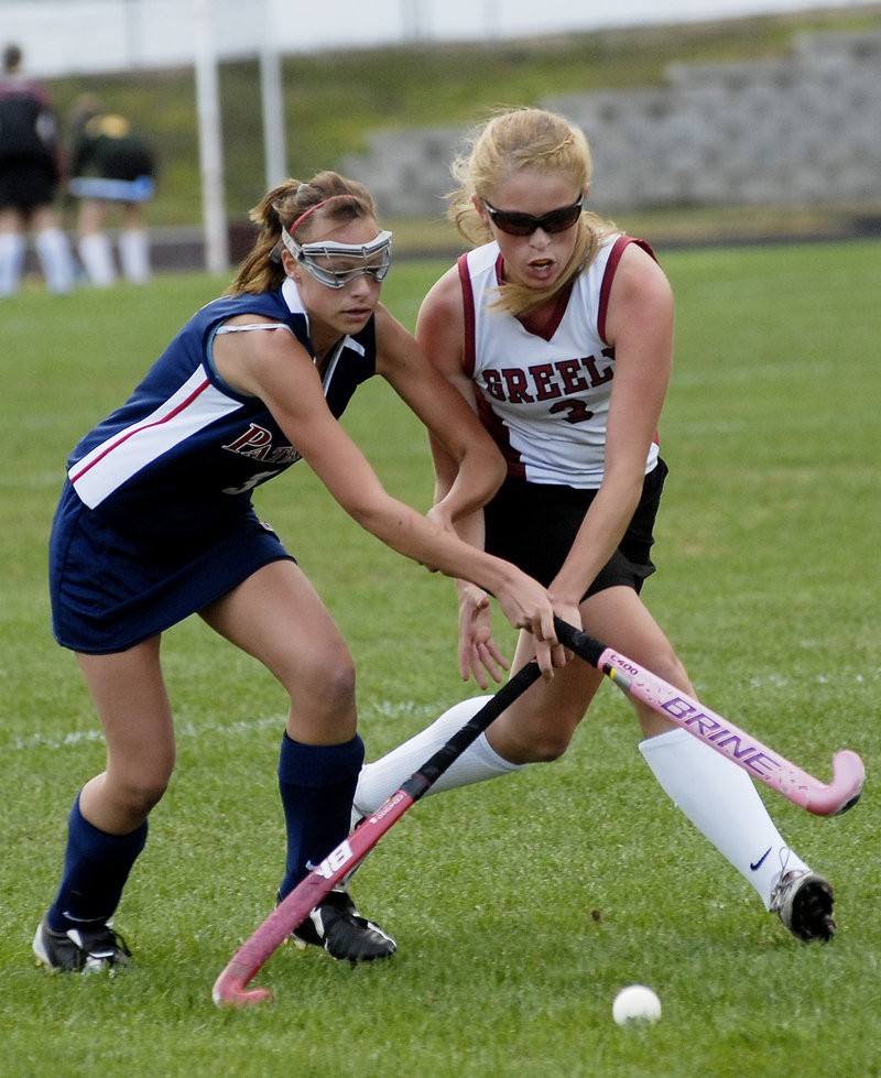Jenna Labrecque of Gray-New Gloucester, left, and Jackie Andrews of Greely compete for the ball Wednesday during Greely's 3-0 victory in a Western Maine Conference field hockey game at Cumberland.