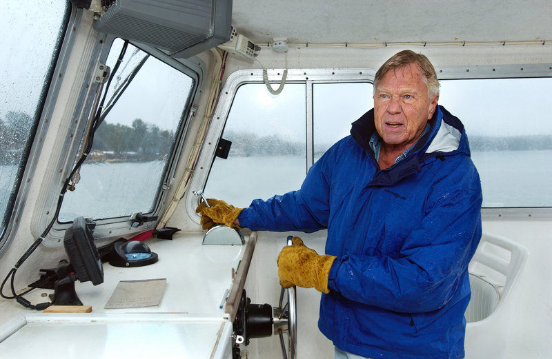 Dodge Morgan guides his boat alongside the dock at his island home in Harpswell during a rainy morning in April 2005. As a young man, he had promised himself he would sail around the world after he turned 30.
