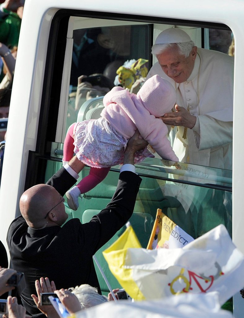 Pope Benedict XVI greets Maria Pyszczak as he arrives at Bellahouston Park in Glasgow, Scotland, on Thursday.