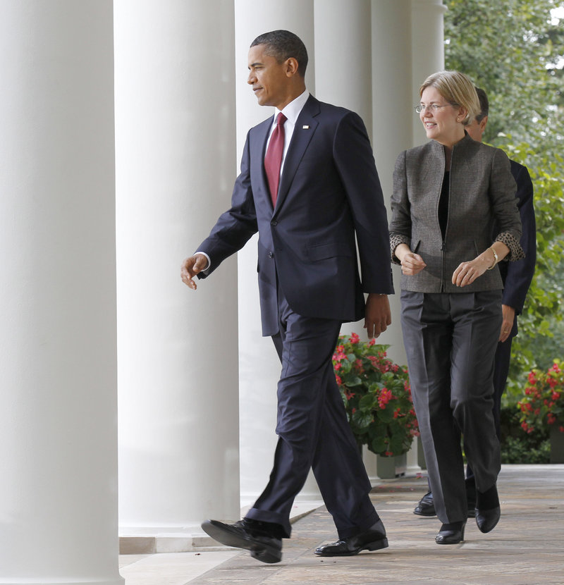 President Obama walks in front of Elizabeth Warren on his way to announce that she will set up the new Bureau of Consumer Financial Protection.