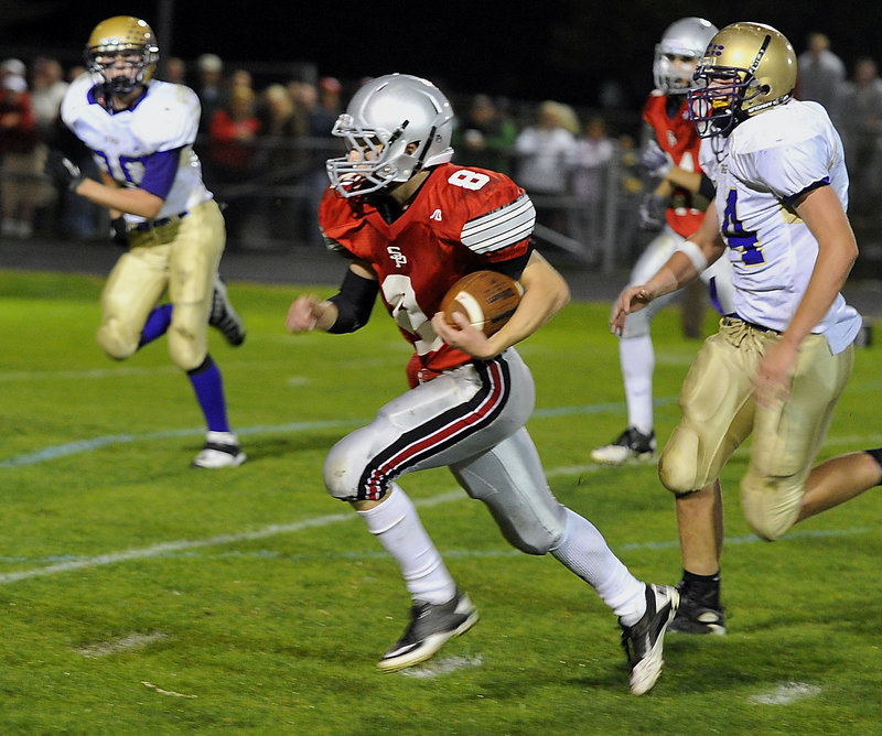 South Portland quarterback Tommy Ellis outruns the Cheverus defense to score on a 30-yard run in the first half Friday night at South Portland. Ellis led the Red Riots in rushing with 92 yards. Cheverus won, 45-21.