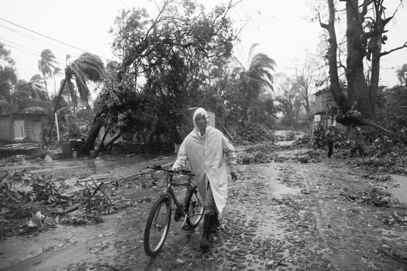 A man walks his bicycle on a street littered with debris after the passage of Hurricane Karl in La Antigua in the Mexican state of Veracruz on Friday. Karl, which hit the Gulf Coast near Veracruz with winds of 115 mph, dissipated today.